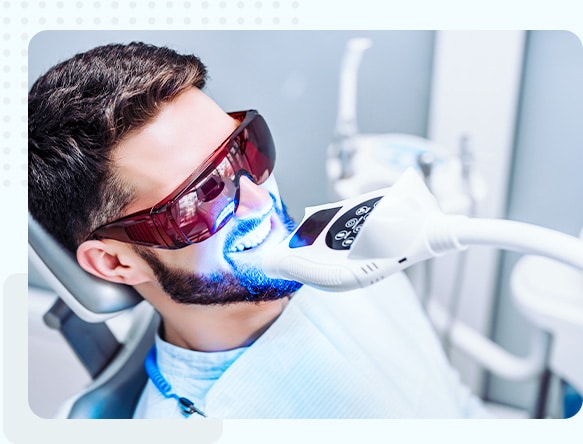 Patient receiving a professional teeth whitening treatment