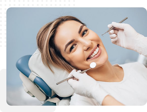 Patient smiling after receiving a full-mouth restoration